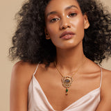 A woman wearing a grey floral semi-precious stone necklace with gold accents.