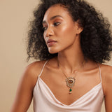 A person wearing a brown floral design necklace with semi-precious stones.